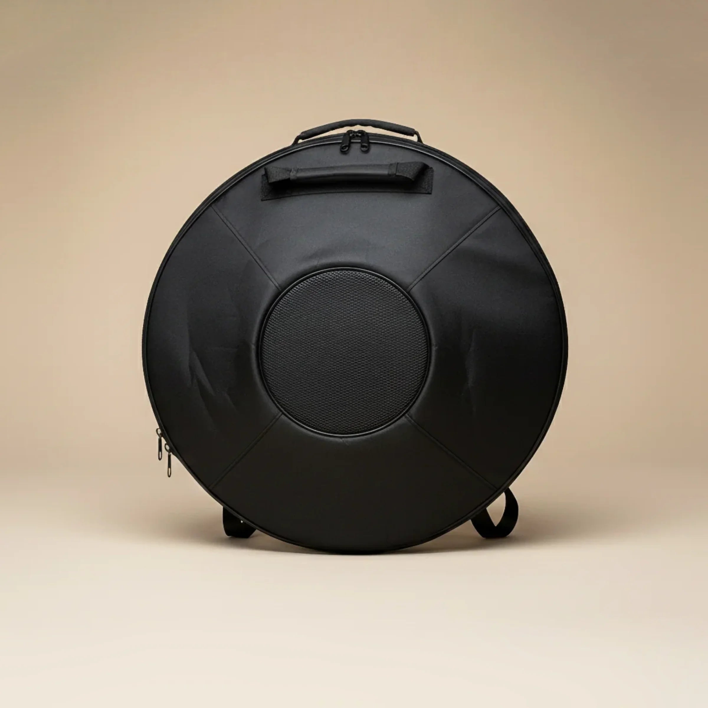Black drum case on a beige background
