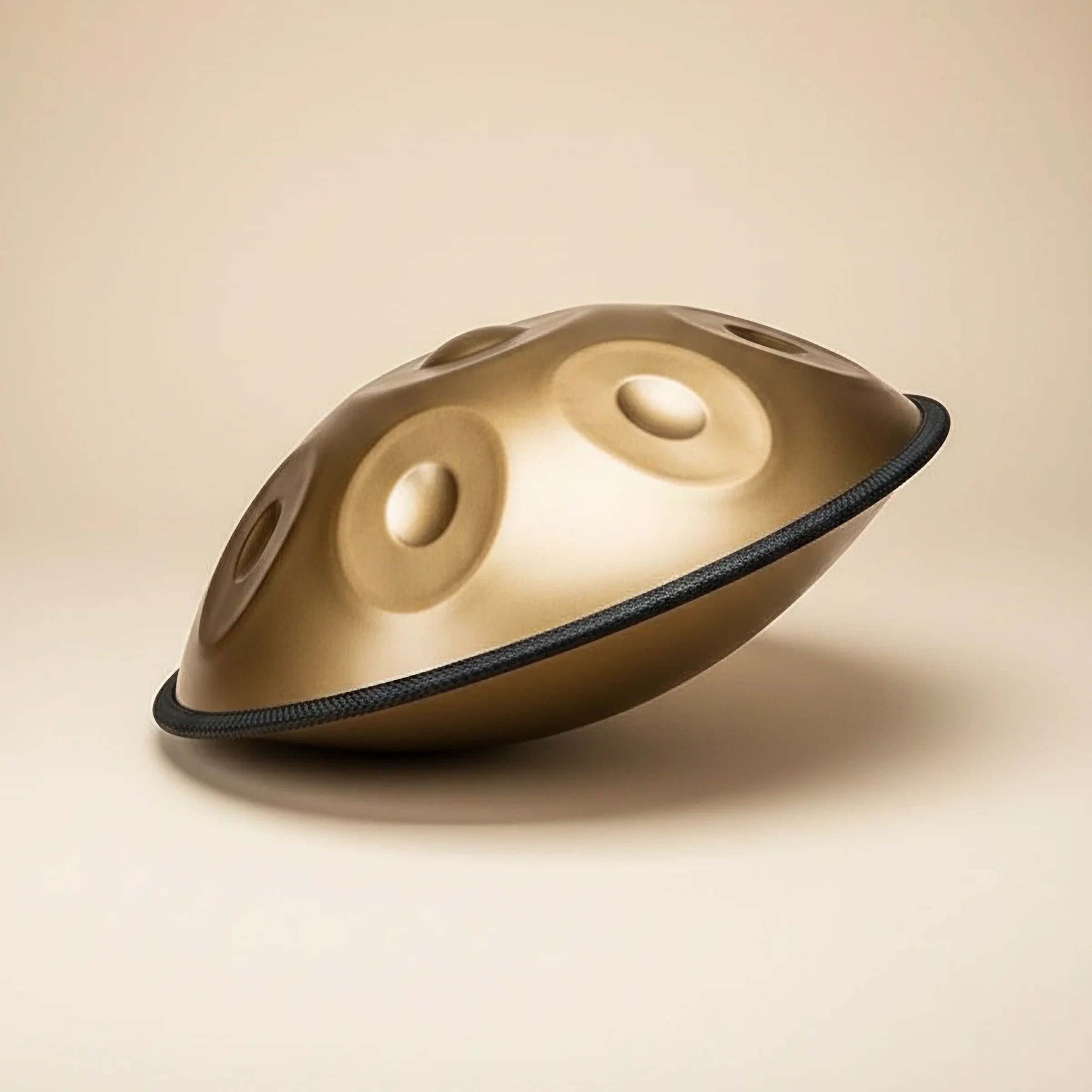 Gold handpan on a beige background