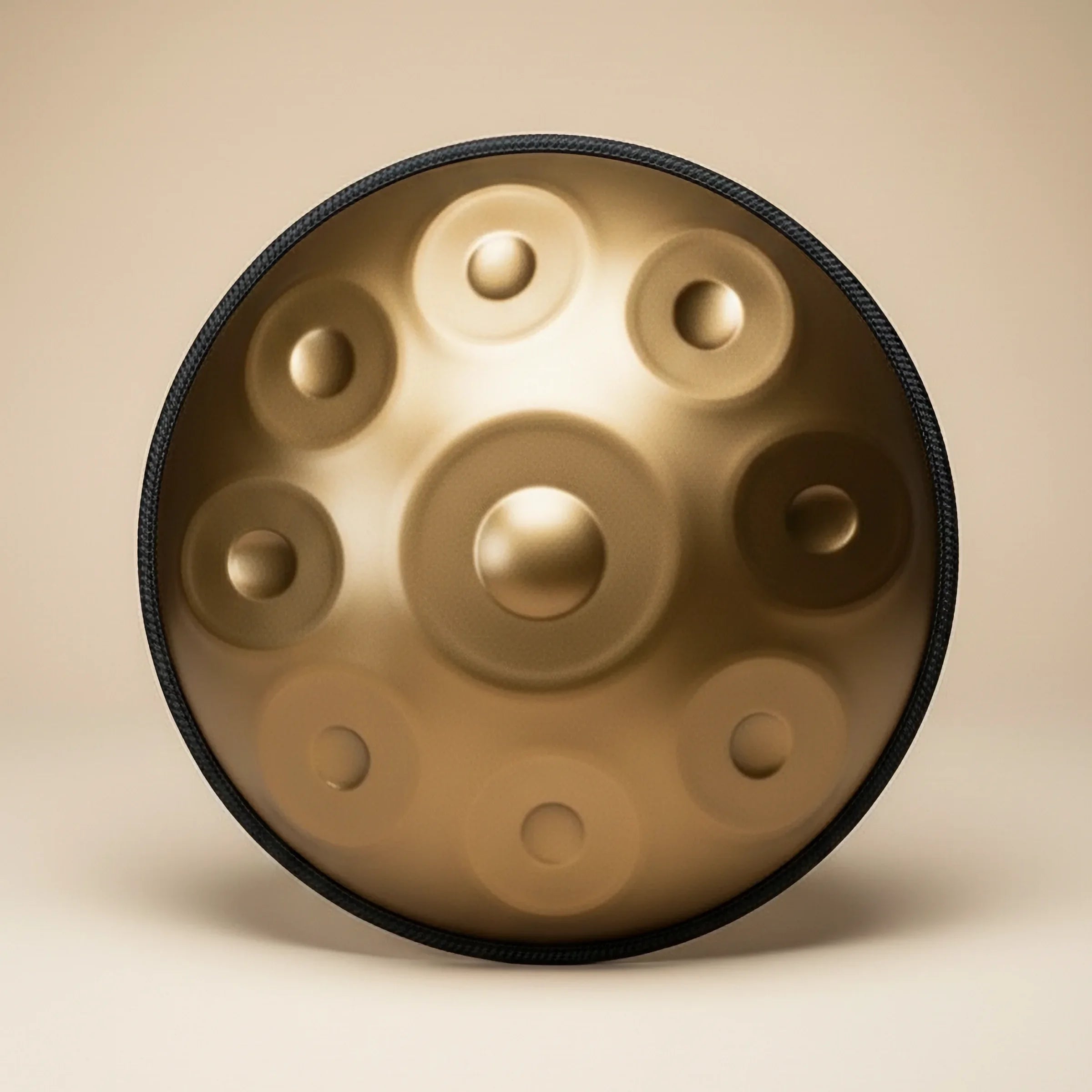 Gold handpan on a beige background