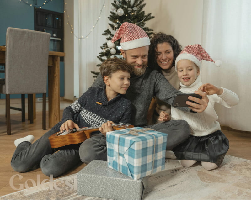 A happy family enjoying Christmas with a Goldesi ukulele gift.