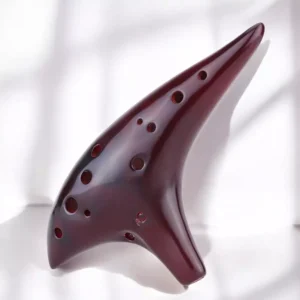 Goldesi red ceramic ocarina top view detail highlighting smooth surface and hole alignment
