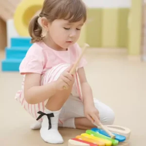 Poster featuring a cute child playing a colorful xylophone, promoting Goldesi’s product