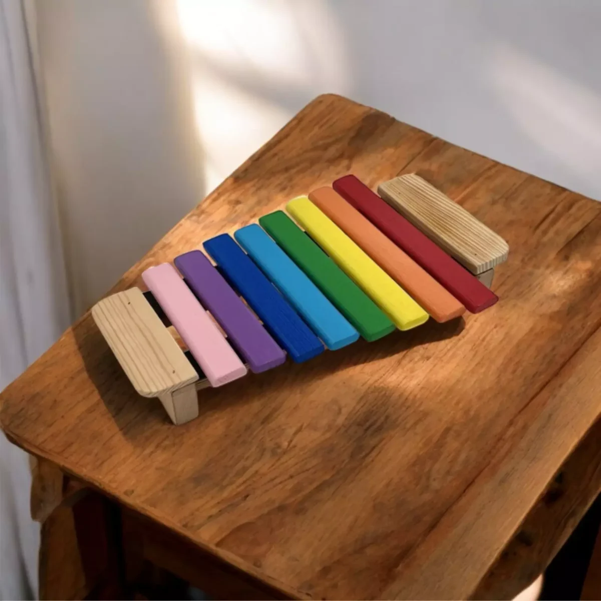 Colorful Goldesi xylophone placed on a coffee table in a cozy home setting